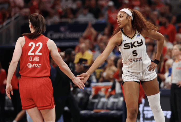 Caitlin Clark of the Indiana Fever and Angel Reese of the Chicago Sky meet at midcourt before tipoff of the Fever's home opener in Indianapolis on Saturday. Gregory Shamus / Getty Images